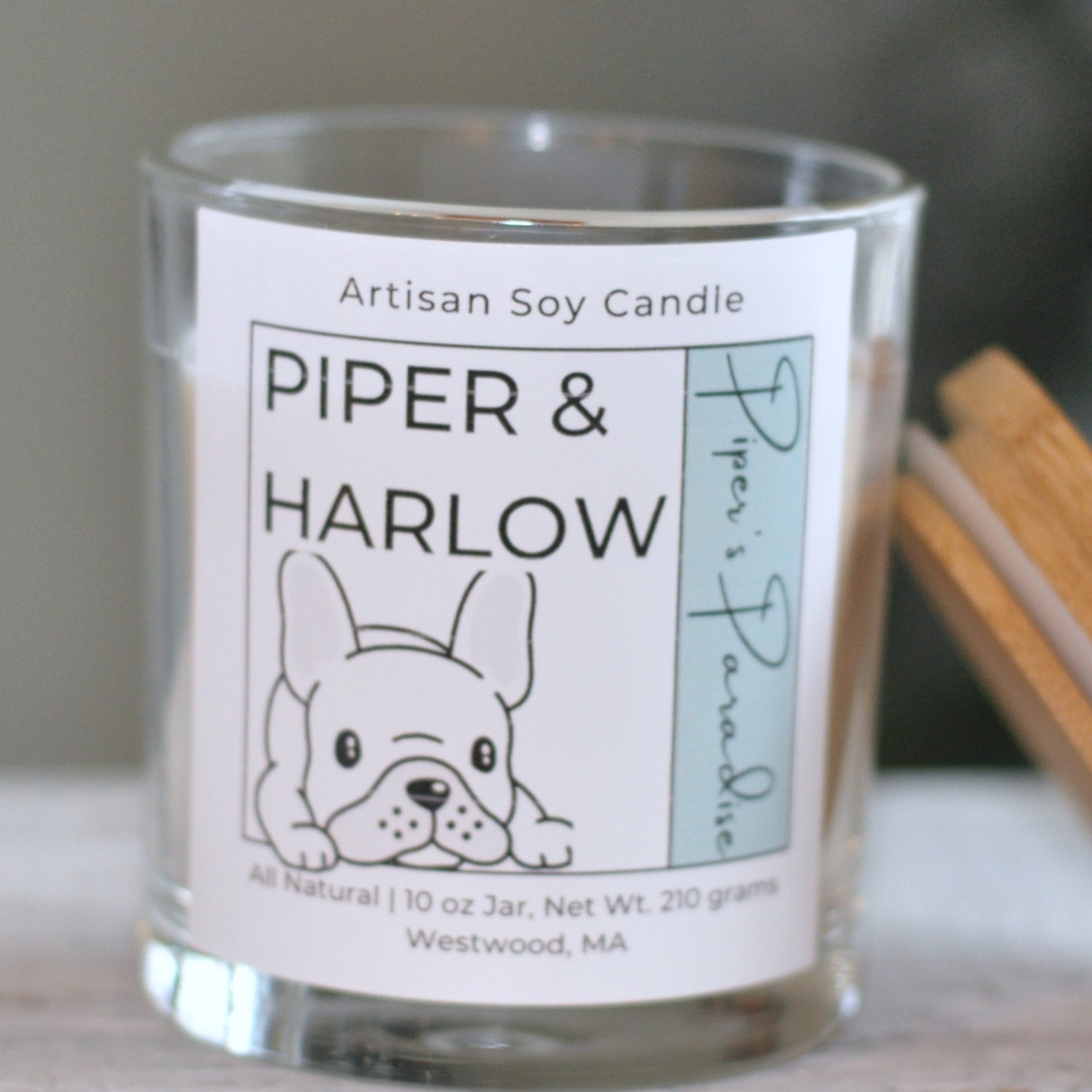 10 oz soy candle in scent Piper's Paradise in glass jar. There is a french bulldog on the label and wood lid.