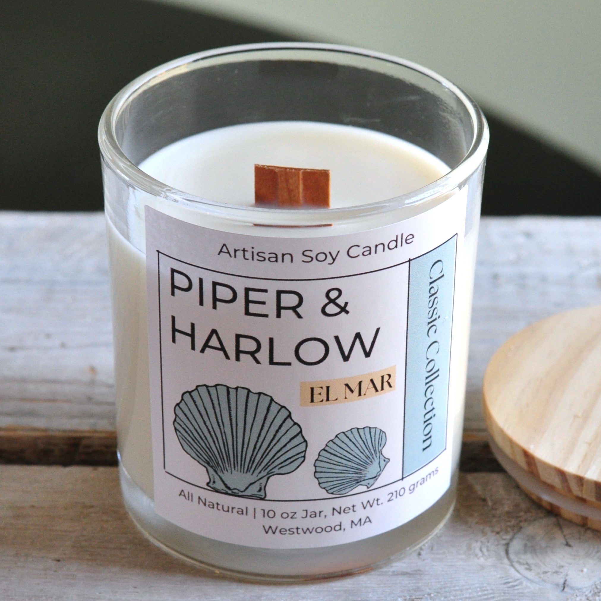 Big Sky scented soy candle in clear glass jar with wood lid and wood wick.