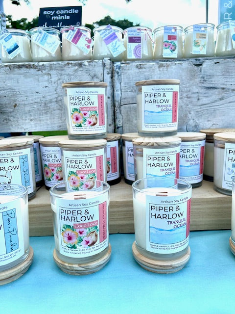 group of candles in glass containers with wood wicks. Scents are coco loco and tranquil ocean